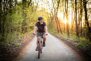 senior man on bike after rehabilitation